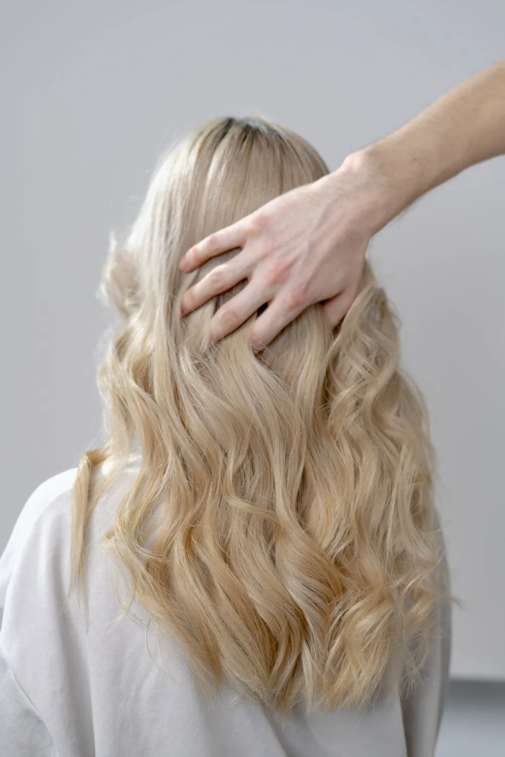 Illustrative stock photograph of long blonde hair styled in curls